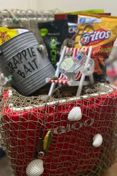 a red bucket filled with candy and other items