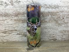 the tumbler is decorated with an image of a deer