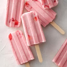 strawberry ice cream popsicles on a white surface