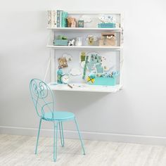 a blue chair sitting in front of a white shelf