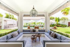 an outdoor living area with couches and tables