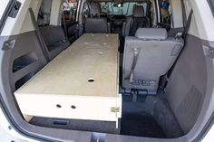 the back end of a van with tables in it