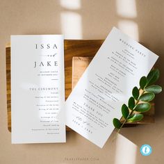 the wedding stationery is laid out on a wooden tray and ready to be used