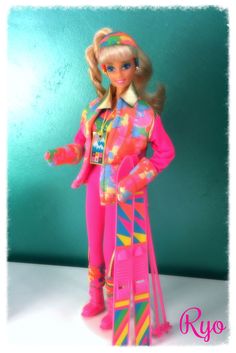 a barbie doll is standing with her skis and poles in front of a green wall