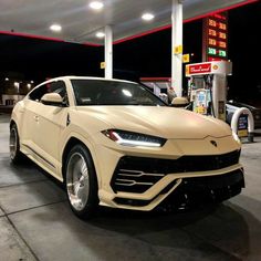 a white car parked in front of a gas station