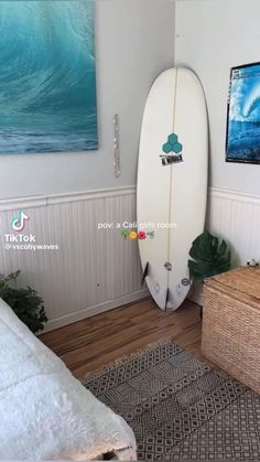 there are two surfboards in the corner of this room