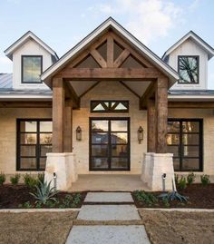 the front entrance to a home with stone steps leading up to it's entry