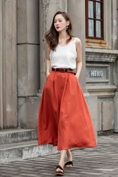 "DETAIL * 100% Linen * Two side pockets * Back elastic waist * Button down skirt * Button front skirt * Below Knee Length * A Line skirt, Midi skirt * Perfect for Spring, Summer and Autumn * Wash by hand or machine with cold water * Model's belt is not sale item * The model is 170 cm (5′ 7″) tall with a 80 cm (31.5\") bust, 66 cm (26\") waist. She is wearing in size XS. CUSTOM MADE SERVICE If you * Change other color * Can't find your size in our size Chart * Change the Style * Change the length Orange Skirt Outfit Ideas, Aline Skirt Outfit, Japanese Wardrobe, Orange Skirt Outfit, Linen Skirt Midi, A Line Skirt Outfits, Pack List, Linen Midi Skirt, Plain Skirt