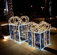 christmas lights are wrapped around boxes on the sidewalk