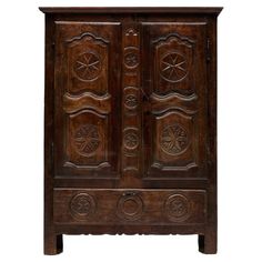 an old wooden cabinet with carvings on the doors