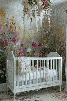 a white crib in front of a floral wallpaper with flowers on it and a chandelier hanging from the ceiling