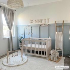 a baby's room with a crib, rocking horse and teddy bear on the floor