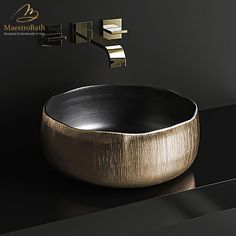 a black and gold bathroom sink with faucet