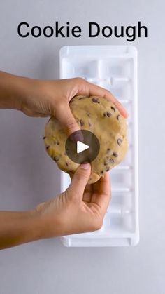 a person holding a cookie doughnut in their hand with the words cookie dough on it