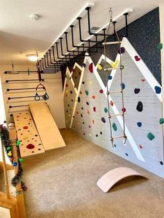 an indoor climbing wall in a child's playroom with climbing bars and ladders