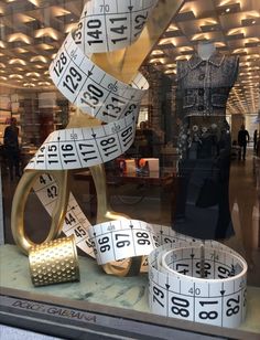 a window display with tape measures in it