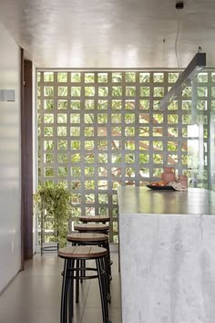 an open kitchen and dining area with stools