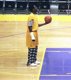 a man in an orange shirt holding a basketball