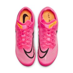 a pair of pink nike shoes with black and orange details on the upper part of the shoe