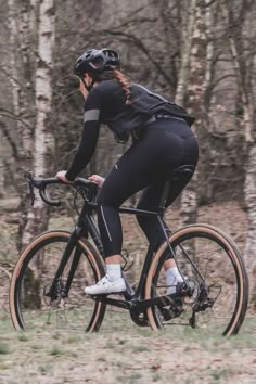 a person riding a bike in the woods