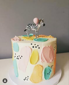 a cake with a zebra figurine on top of it