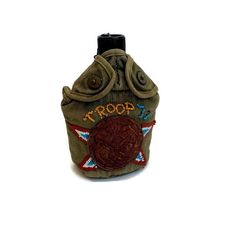 a small purse with the word troop embroidered on it's front and back side