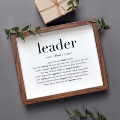 a sign that says leader next to a gift box