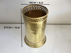 a brass cup is shown with measurements for the size and width to be used on it