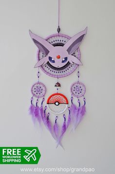 a pink and purple dream catcher hanging from a wall