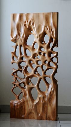 a sculpture made out of wood with holes in it