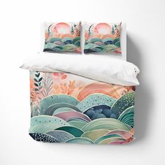 a bed with two pillows on top of it next to a pillow case that has an ocean scene