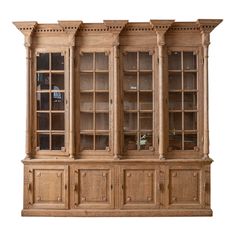 an old wooden bookcase with glass doors on the top and bottom, against a gray background