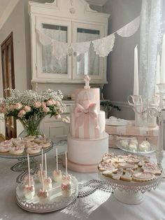 a table topped with cakes and cupcakes covered in frosting