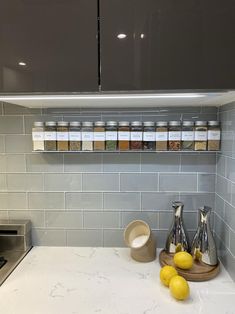 a kitchen counter with spices and lemons on it