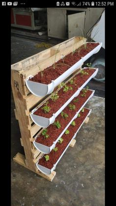 three tiered wooden planter with plants growing in it