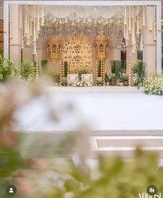 an outdoor wedding setup with flowers and greenery