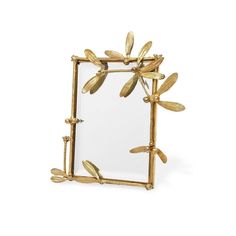 a mirror with gold leaves on it and a glass frame in the shape of a dragonfly