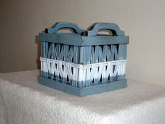 a blue and white basket sitting on top of a table