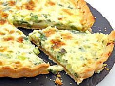 a quiche with broccoli and cheese is cut into slices