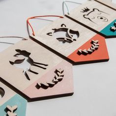 four wooden tags with different designs on them