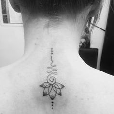 a woman with a tattoo on her back neck