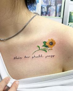 a woman with a sunflower tattoo on her shoulder that says, she's the smile most