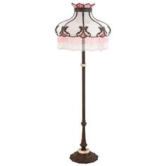 a floor lamp with a pink shade on it