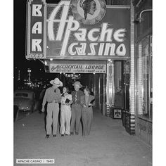 an old black and white photo of some people standing in front of a casino sign