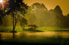 a gazebo sitting on top of a small island in the middle of a lake