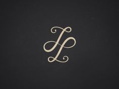 the letter j is made up of swirls and scrolls in gold on black paper