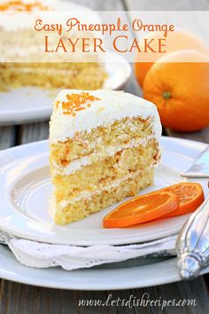 a slice of cake on a white plate with an orange and fork next to it