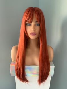 Add some sizzle to your style with our "Trina" Wig. Made of synthetic fibers and measuring an impressive 26 inches, you'll be sure to stand out with its silky straight strands and fiery red hue. Bangs add a flirty touch, so you'll be ready to turn heads with this sassy and fun look. Red Hair Olive Skin, Red Hair With Bangs, Straight Wig With Bangs, Olive Skin, Wig With Bangs, Fiery Red, Long Red, Straight Wig