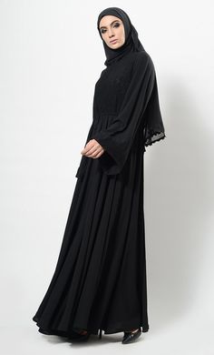 Featuring a beautiful modest wear flared abaya dress in nida basie adorned with self woven floral lace panel covering the top of the bodice and edges of bell style loose sleeves. It has drawstring detailing around the waist and is comfortable to be worn both for informal and formal ocassions.FIT : Relaxed fit.COMPOSITION : Nida.CARE : Dry clean only. Modest Flowy Maxi Length Abaya, Flowy Maxi-length Abaya For Eid, Flowy Long Abaya For Eid, Modest Solid Color Floor-length Abaya, Modest Floor-length Abaya, Elegant Maxi Length Niqab For Eid, Solid Color Abaya With Modesty Panel For Eid, Elegant Flowy Abaya For Eid, Eid Abaya With Modesty Panel In Solid Color