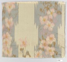 a piece of cloth with pink flowers on it and an orange stripe in the middle